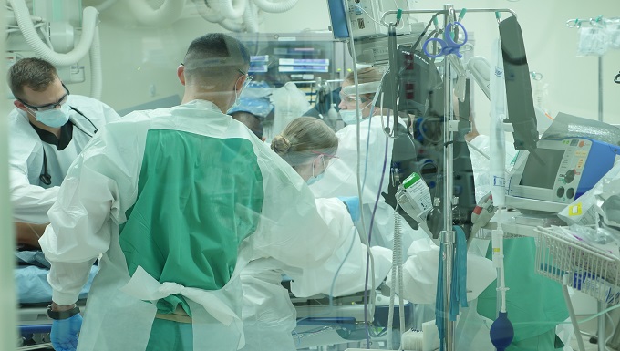 A Brooke Army Medical Center trauma team examines a patient in the emergency department.